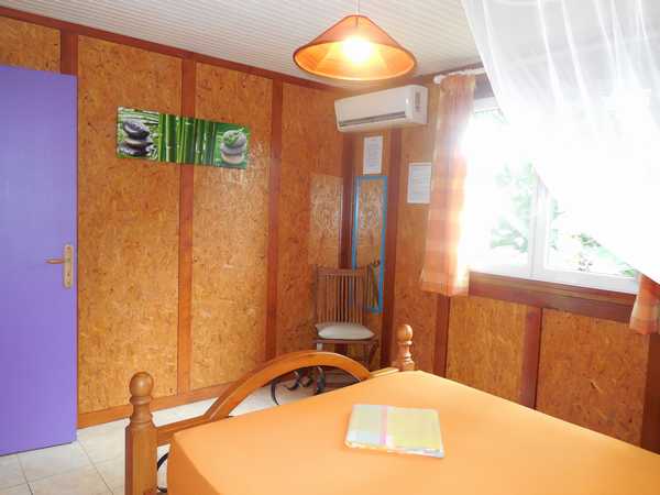 The air-conditioned double bedroom, with baby cot space