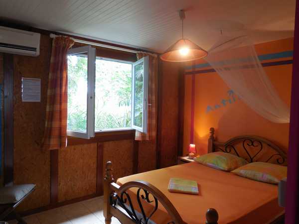 The bedroom of the Antilles lodging, in Lamateliane cottages